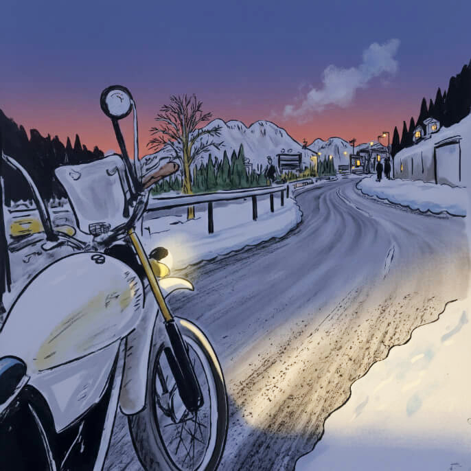 Motorcycle on a snow covered road under the Italian Dolomites.