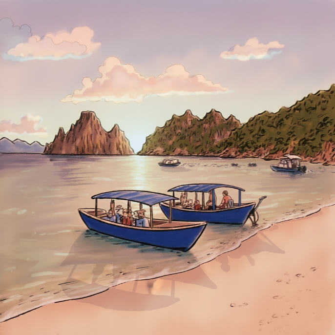 Boats on the sandy white shoreline on the island of Langkawi in Malaysia.