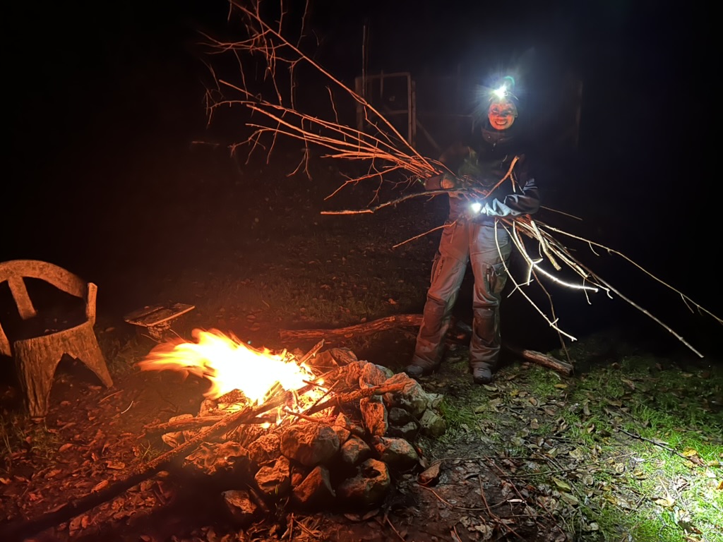 Kelly starting a damp fire.